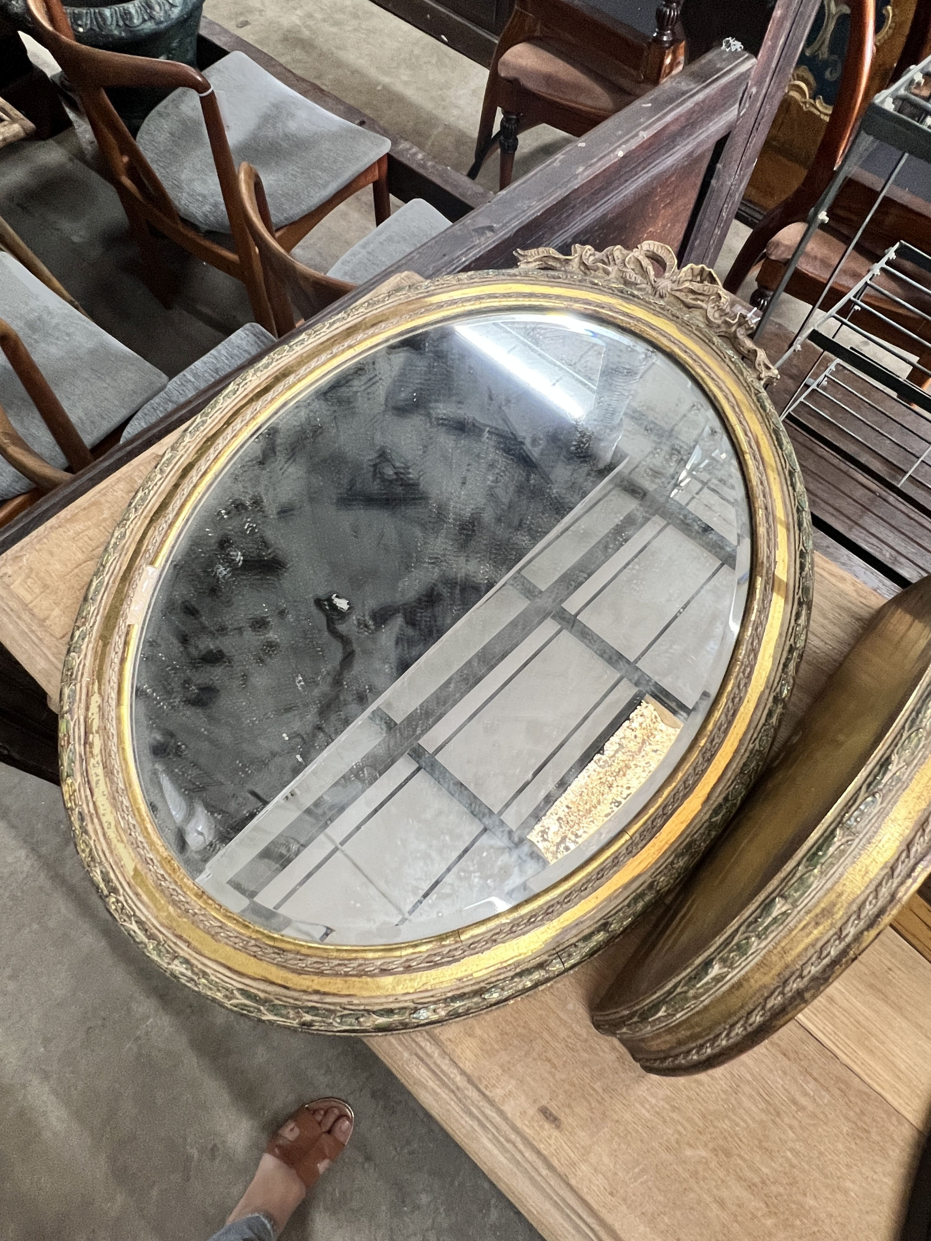 An oval gilt framed wall mirror, height 70cm, a matching wall bracket and an oval chinoiserie lacquered wall mirror, height 48cm
